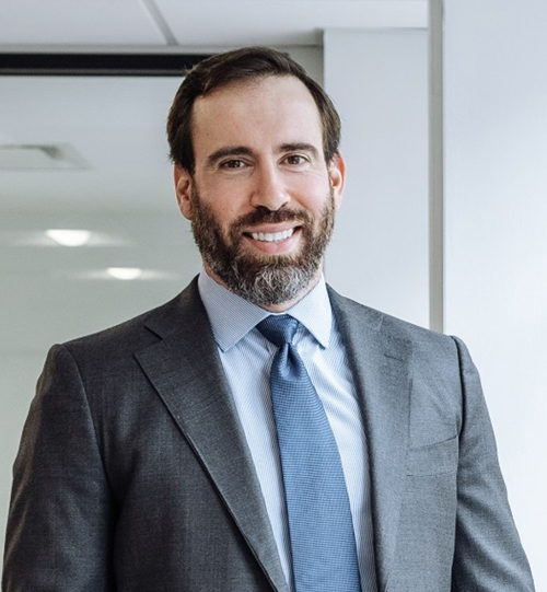 Smiling businessman in gray suit.