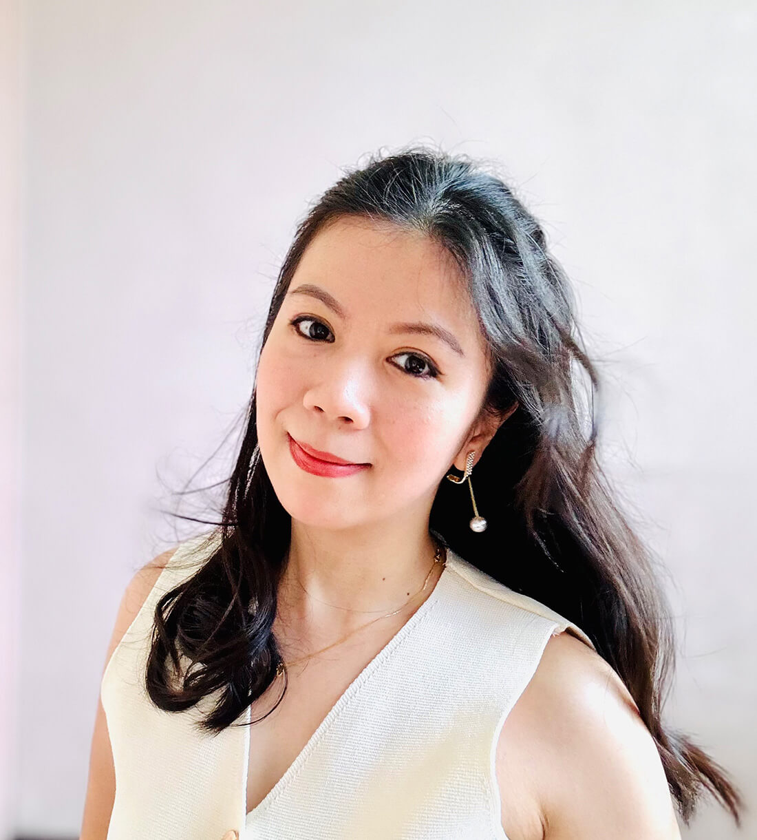 Smiling woman with long, dark hair.