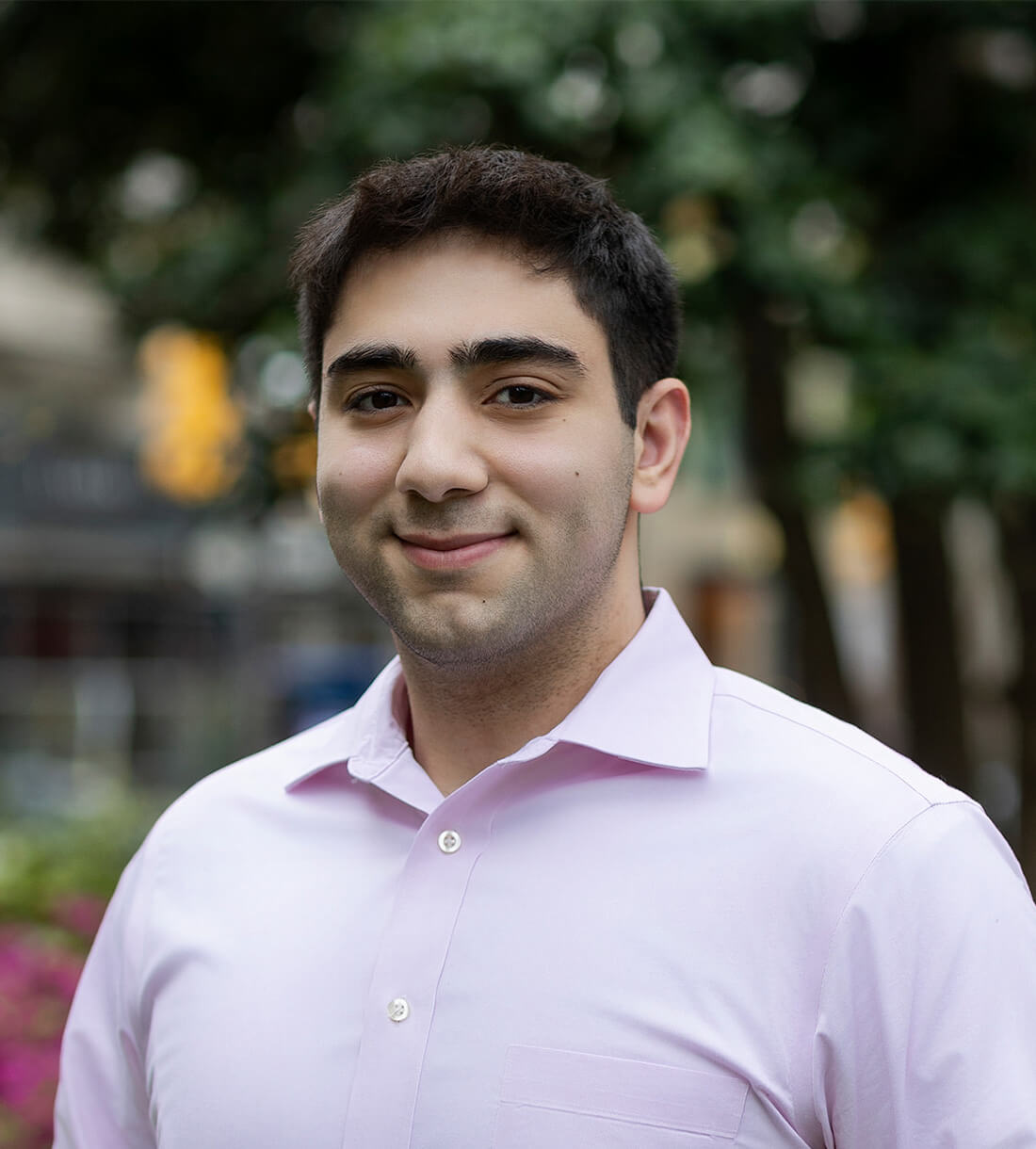 Smiling person outdoors in a light shirt.