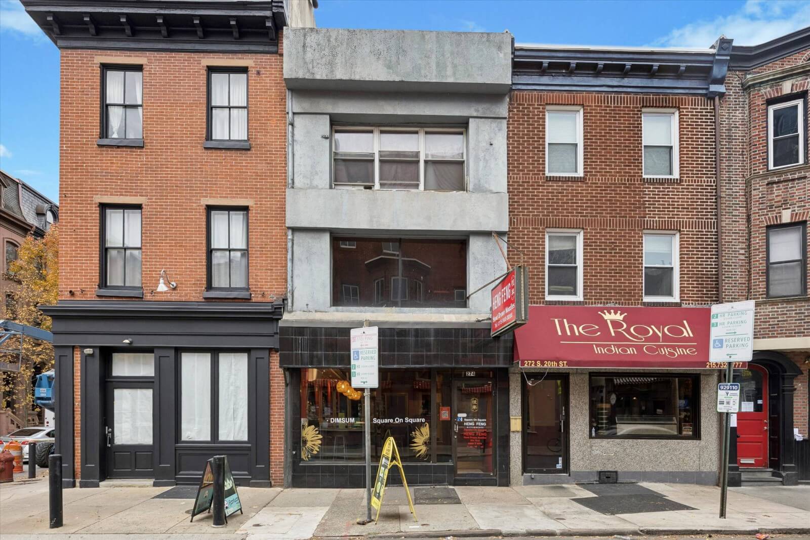 Historic brick buildings with storefronts and signs.